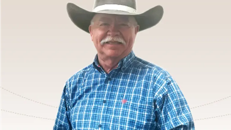 Picture of man with a moustache in a cowboy hat and blue shirt.